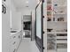 Well-organized white pantry featuring open shelving, pull-out wire baskets and easy access to garage at 20307 74Th E Ave, Bradenton, FL 34202