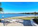 Beautiful backyard with a view of the lake, a lounge chair, and lush landscaping at 227 Maraviya Blvd, Nokomis, FL 34275