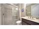 Tiled bathroom with glass shower, vanity sink, and neutral tones at 227 Maraviya Blvd, Nokomis, FL 34275