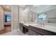 Bathroom featuring dual sink vanity with white countertop and access to main bedroom at 227 Maraviya Blvd, Nokomis, FL 34275