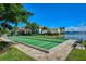 Outdoor bocce ball court next to a serene lake in the community, with a beautiful clubhouse at 227 Maraviya Blvd, Nokomis, FL 34275