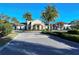 Beautiful clubhouse facade featuring classic architectural design and lush tropical landscaping at 227 Maraviya Blvd, Nokomis, FL 34275