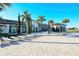 Community clubhouse with lounge chairs, landscaped grounds, and picturesque palm tree views at 227 Maraviya Blvd, Nokomis, FL 34275