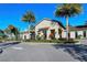 Elegant clubhouse with stone accents and a well-maintained driveway and landscaped entrance at 227 Maraviya Blvd, Nokomis, FL 34275