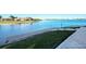 Lake view with a wooden dock and lush landscaping, offering a tranquil waterfront experience at 227 Maraviya Blvd, Nokomis, FL 34275