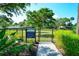 Fenced dog park with lush landscaping and clear signage indicating park rules in the community at 227 Maraviya Blvd, Nokomis, FL 34275