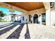 Covered entrance to the clubhouse featuring stone columns, arched doors, and lush surroundings at 227 Maraviya Blvd, Nokomis, FL 34275