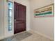 Welcoming entryway features a mahogany front door and beautiful artwork at 227 Maraviya Blvd, Nokomis, FL 34275