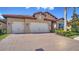 Stunning home with a red tile roof and a brick driveway leading to a two-car garage at 227 Maraviya Blvd, Nokomis, FL 34275