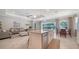 Bright, open kitchen featuring a large island, stainless steel appliances and a view to the outdoor living area at 227 Maraviya Blvd, Nokomis, FL 34275