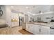 Open-concept kitchen with white cabinetry, granite countertops, and stainless steel appliances at 227 Maraviya Blvd, Nokomis, FL 34275
