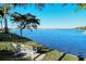 Scenic view of a lake with a bench on the shoreline, offering a peaceful spot to relax and enjoy the community at 227 Maraviya Blvd, Nokomis, FL 34275