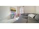 Comfortable living room with an L-shaped couch and a view of a window that allows natural light to filter in at 227 Maraviya Blvd, Nokomis, FL 34275