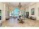 Grand lobby with travertine flooring, elegant seating, and views of tropical landscapes through large windows at 227 Maraviya Blvd, Nokomis, FL 34275