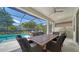 Screened-in lanai with a dining area and an outdoor grill, perfect for entertaining at 227 Maraviya Blvd, Nokomis, FL 34275