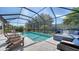 Inviting screened-in pool area with comfortable seating and a serene outdoor setting at 227 Maraviya Blvd, Nokomis, FL 34275
