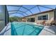 Relaxing screened-in pool area with comfortable lounge chairs on the pool deck at 227 Maraviya Blvd, Nokomis, FL 34275
