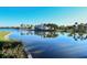 Scenic waterfront view of community buildings, reflected in the calm, serene lake at 227 Maraviya Blvd, Nokomis, FL 34275
