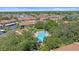 Aerial view of the property showing the community pool and surrounding trees at 2640 Clubhouse Dr # 204, Sarasota, FL 34232