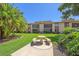 Well-maintained backyard with mature palms, picnic seating and lush landscaping at 2640 Clubhouse Dr # 204, Sarasota, FL 34232