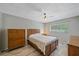 Bedroom featuring wood floors, ceiling fan, and a light-filled window at 2640 Clubhouse Dr # 204, Sarasota, FL 34232