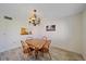Bright dining area with wood table and chairs, and serving hatch to kitchen for easy serving at 2640 Clubhouse Dr # 204, Sarasota, FL 34232