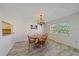 Bright dining area with wood table and chairs, and large window to enjoy outdoor views at 2640 Clubhouse Dr # 204, Sarasota, FL 34232