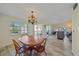 Dining room with wood table and chairs, bright windows and easy access to a screened lanai at 2640 Clubhouse Dr # 204, Sarasota, FL 34232
