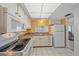 Practical kitchen design with appliances and tiled floor, seamlessly connected to dining area at 2640 Clubhouse Dr # 204, Sarasota, FL 34232