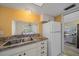 Bright kitchen featuring white appliances and countertops, open to the dining area at 2640 Clubhouse Dr # 204, Sarasota, FL 34232