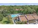Aerial view of community pool with lounge chairs surrounded by mature landscaping at 2640 Clubhouse Dr # 204, Sarasota, FL 34232