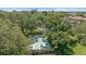 Aerial view of the community shuffleboard with surrounding mature landscaping and seating at 2640 Clubhouse Dr # 204, Sarasota, FL 34232