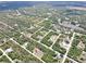 Aerial view of this neighborhood nestled among natural Florida landscape at 27207 Treadmill Dr, Punta Gorda, FL 33955