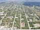 Expansive aerial view showing property location in a community with established streets and lush greenery at 27207 Treadmill Dr, Punta Gorda, FL 33955