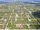 Scenic aerial view highlighting the property's location near a lake in a lush, green community at 27207 Treadmill Dr, Punta Gorda, FL 33955