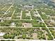 Aerial view of the home in a neighborhood surrounded by natural Florida landscape at 27207 Treadmill Dr, Punta Gorda, FL 33955