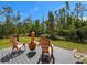 An outdoor deck with patio furniture sits in the backyard of the home at 27207 Treadmill Dr, Punta Gorda, FL 33955
