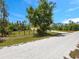 This property sits far back from the road, surrounded by Florida greenery at 27207 Treadmill Dr, Punta Gorda, FL 33955