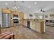 Spacious kitchen with wood cabinets, granite countertops, stainless steel appliances, and wood look tile flooring at 27207 Treadmill Dr, Punta Gorda, FL 33955