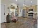 Warm and inviting kitchen with stainless steel appliances, wood cabinetry, and wood look tile flooring at 27207 Treadmill Dr, Punta Gorda, FL 33955