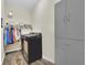 Functional laundry room featuring a modern washer, storage, and ample shelving space at 27207 Treadmill Dr, Punta Gorda, FL 33955