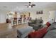 Open-concept living area with hardwood floors, neutral-toned furniture, and an open view to the kitchen at 27207 Treadmill Dr, Punta Gorda, FL 33955