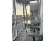 Balcony area with seating and views of the surrounding tropical neighborhood at 2755 Coconut Bay Ln # 1313 3M, Sarasota, FL 34237
