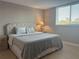 Bedroom with neutral walls, window, and tiled floor, providing a calm and bright atmosphere at 2755 Coconut Bay Ln # 1313 3M, Sarasota, FL 34237