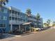 Exterior shot of blue condo building featuring palm trees, lush landscaping and resident parking at 2755 Coconut Bay Ln # 1313 3M, Sarasota, FL 34237