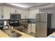 Well-equipped kitchen with stainless steel appliances and granite countertops offers modern convenience at 2755 Coconut Bay Ln # 1313 3M, Sarasota, FL 34237