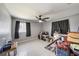 Bedroom with neutral paint, fan and fixtures, light tile flooring, and windows with dark curtains at 3041 Teal Ave, Sarasota, FL 34232