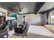 Bedroom featuring sleek black furniture, a flat screen TV, and neutral-toned bedspread at 3041 Teal Ave, Sarasota, FL 34232