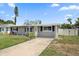 This is a single story home with neutral color scheme, dark shutters, and a well-manicured lawn at 3041 Teal Ave, Sarasota, FL 34232
