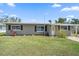 Inviting single-story home with a green lawn, and welcoming curb appeal at 3041 Teal Ave, Sarasota, FL 34232